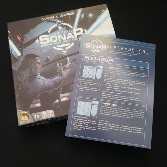 Image shows the front cover of the box of the Captain Sonar board game, with the instructions for the Upgrade One pack sitting on top of it