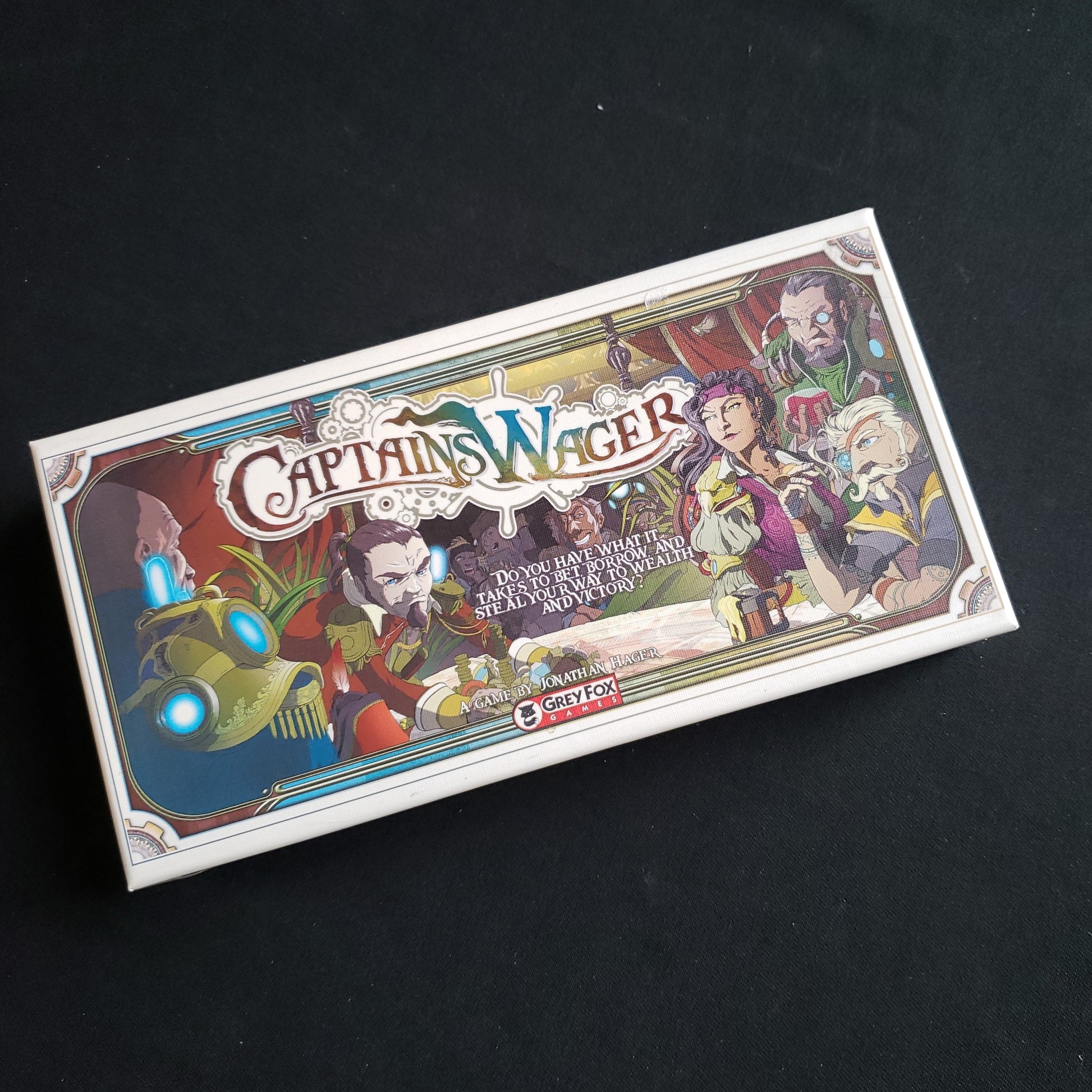 Image shows the front cover of the box of the Captain's Wager card game