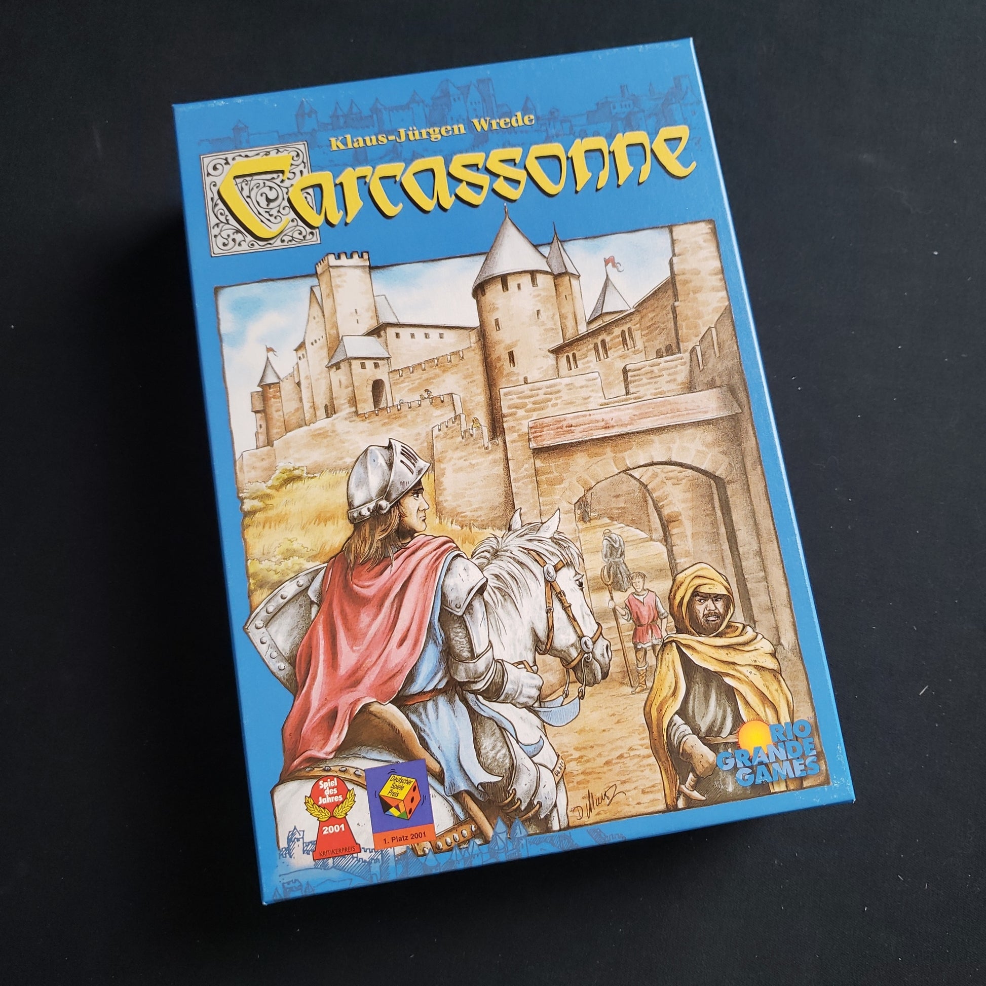 Image shows the front cover of the box of the Carcassonne board game
