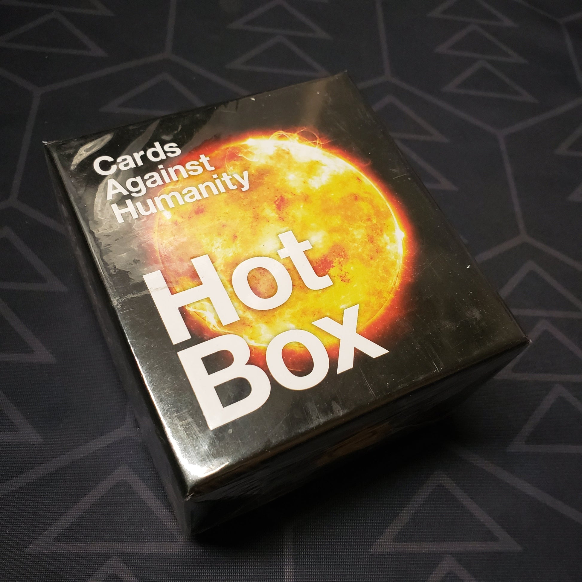 Image shows the front cover of the box of the Hot Box expansion for the card game Cards Against Humanity