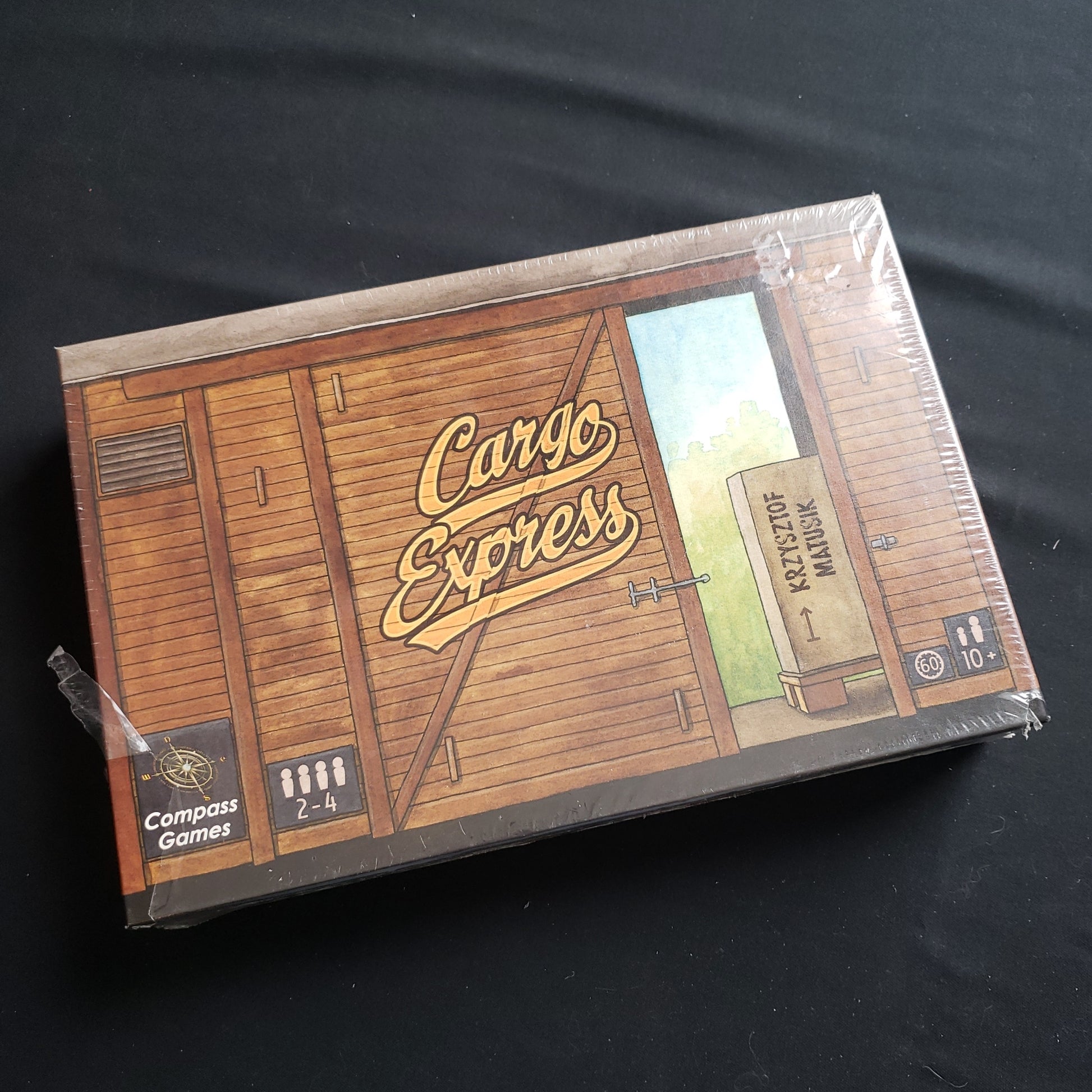 Image shows the front cover of the box of the Cargo Express board game