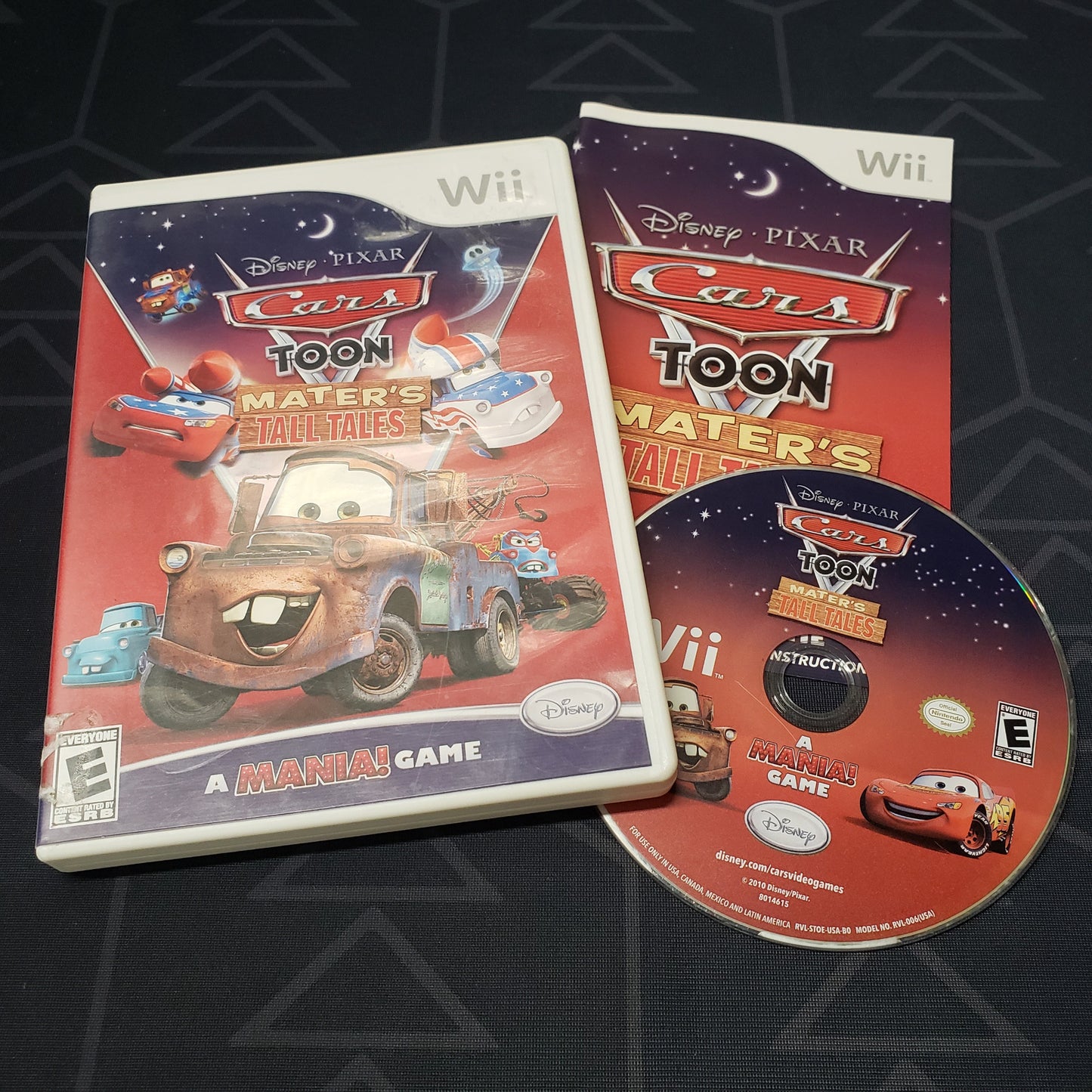 Image shows the case, manual and disc for the video game Cars Toon: Mater's Tall Tales for Nintendo Wii