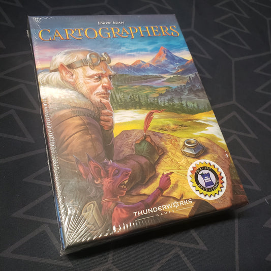 Image shows the front cover of the box for the Cartographers board game