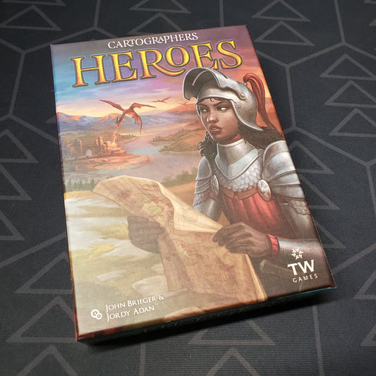Image shows the front cover of the box for the Cartographers: Heroes board game