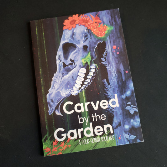 Image shows the front cover of the Carved by the Garden roleplaying game book