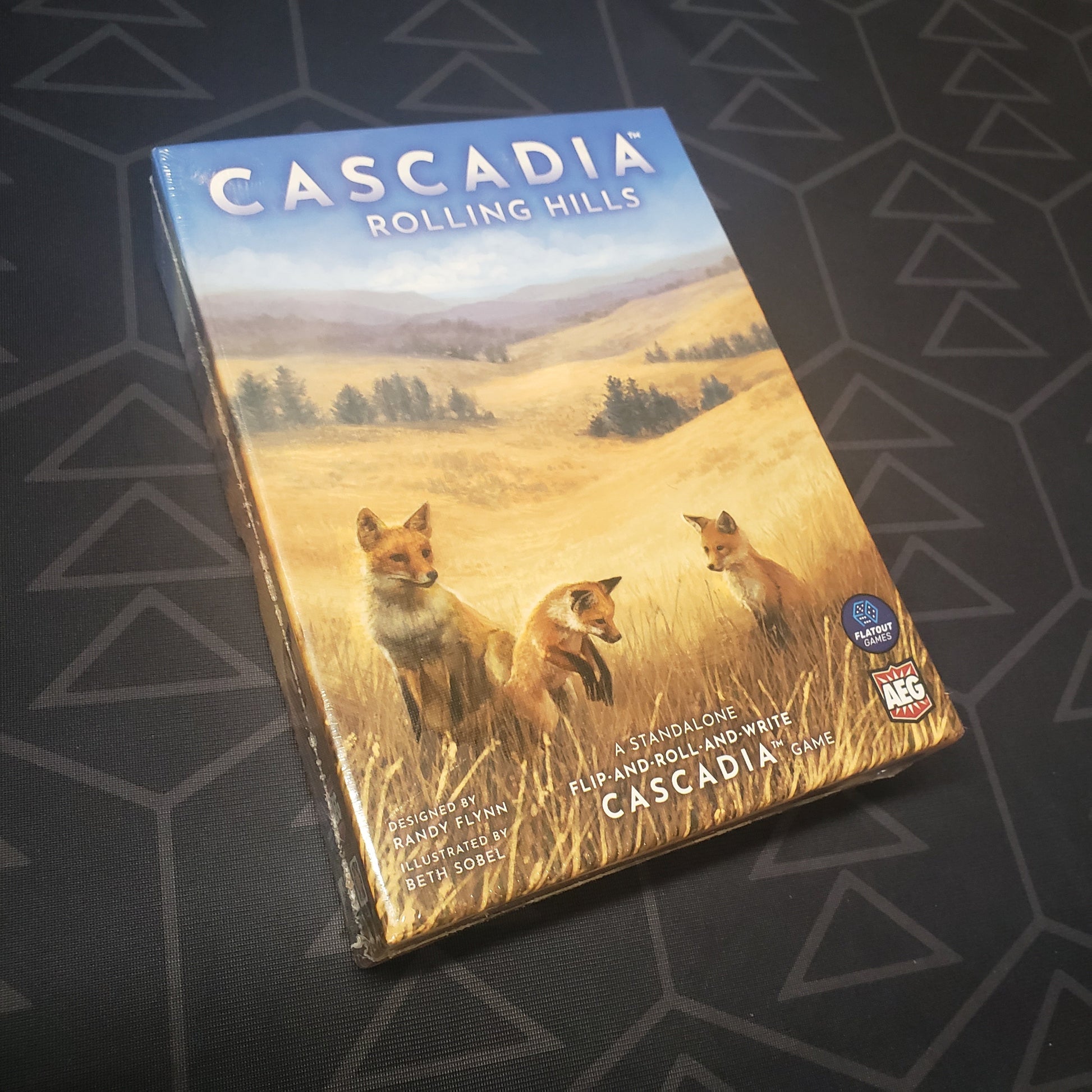 Image shows the front cover of the box for the Cascadia: Rolling Hills board game