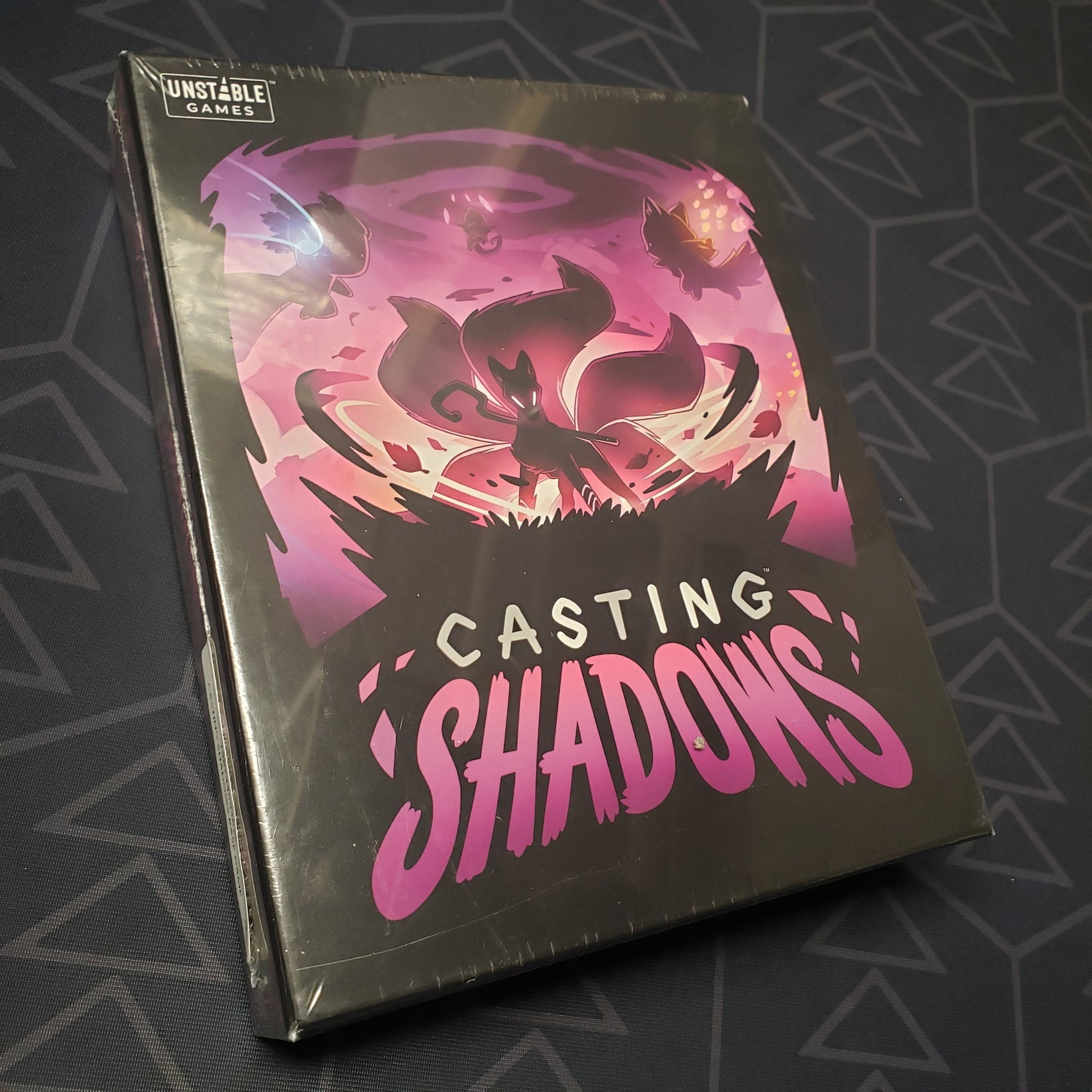 Image shows the front cover of the box for the Casting Shadows board game