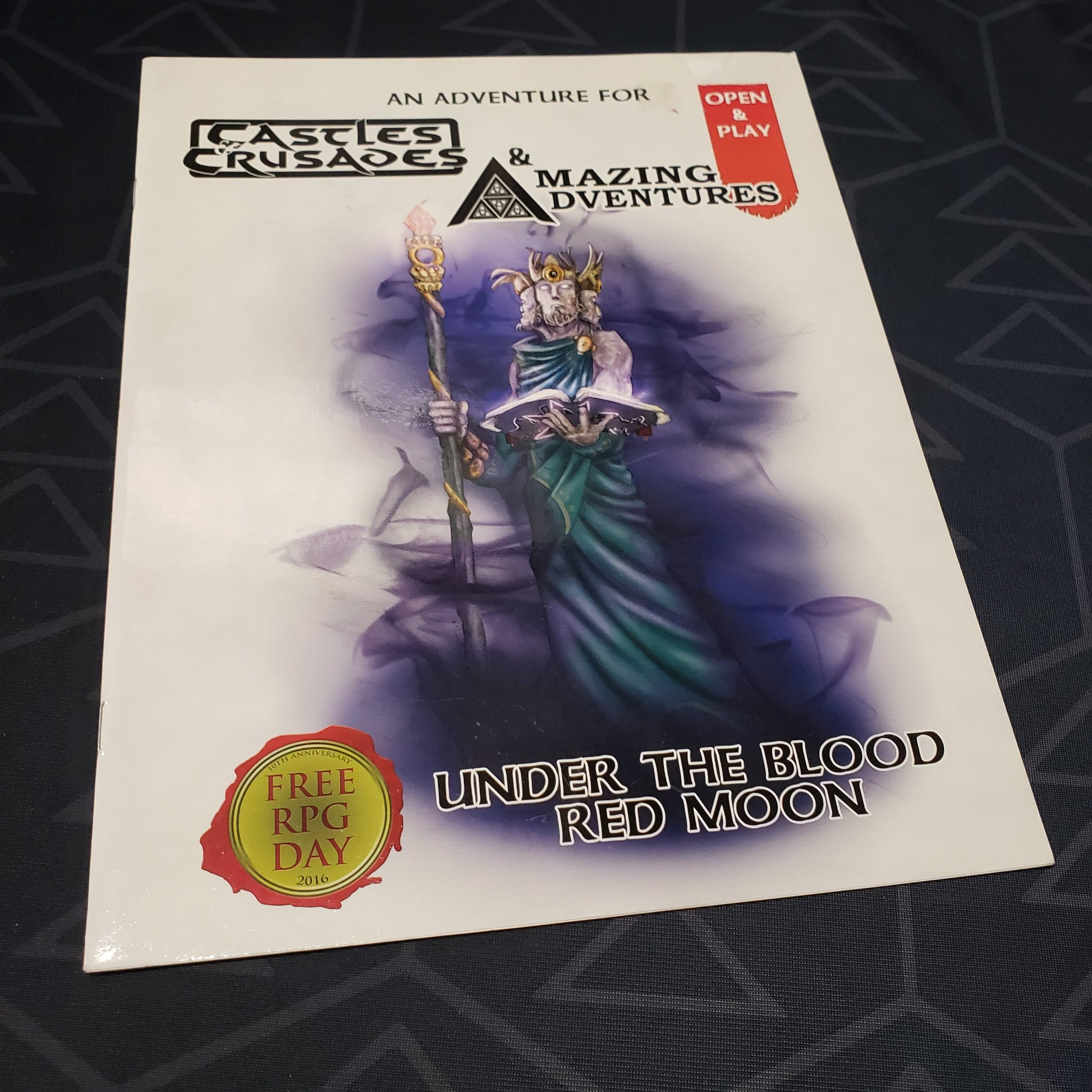 Image shows the front cover of the Under the Blood Red Moon book for the roleplaying game Castles & Crusades