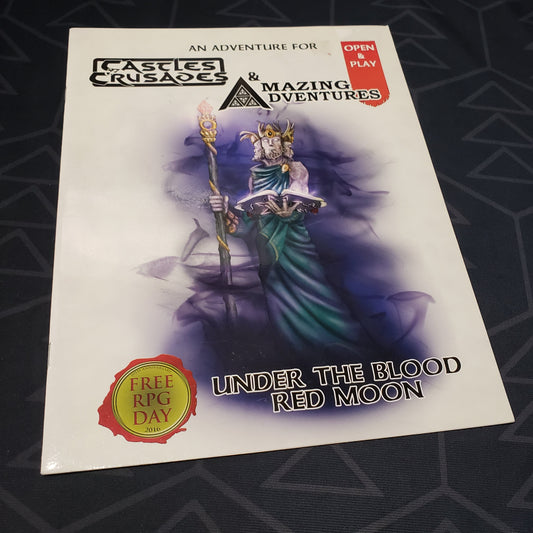 Image shows the front cover of the Under the Blood Red Moon book for the roleplaying game Castles & Crusades