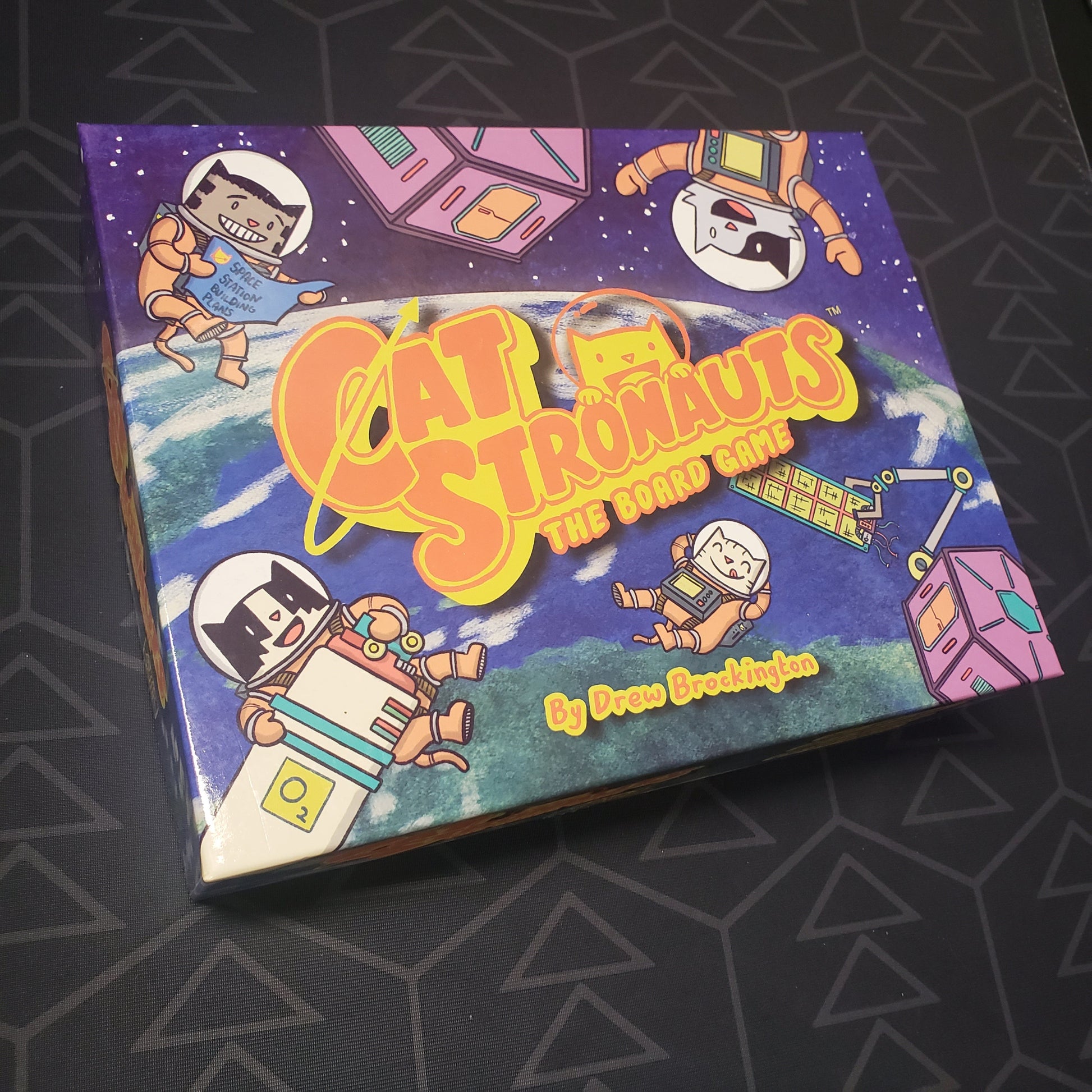 Image shows the front cover of the box for CatStronauts: The Board Game