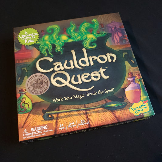 Image shows the front cover of the box of the Cauldron Quest board game