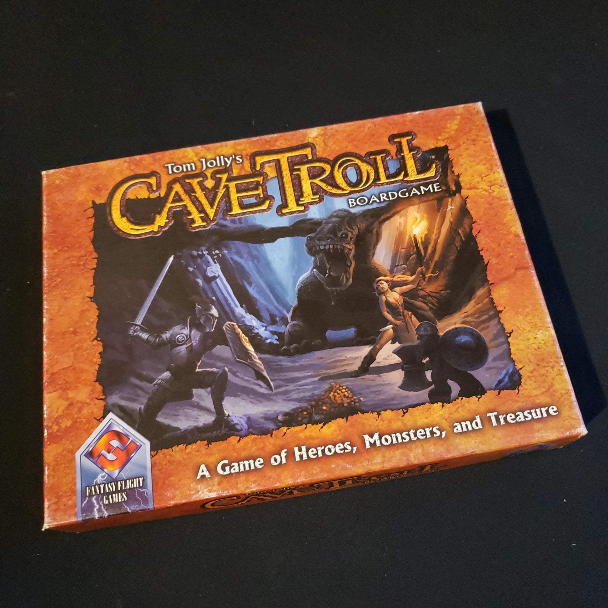 Image shows the front cover of the box of the Cave Troll board game