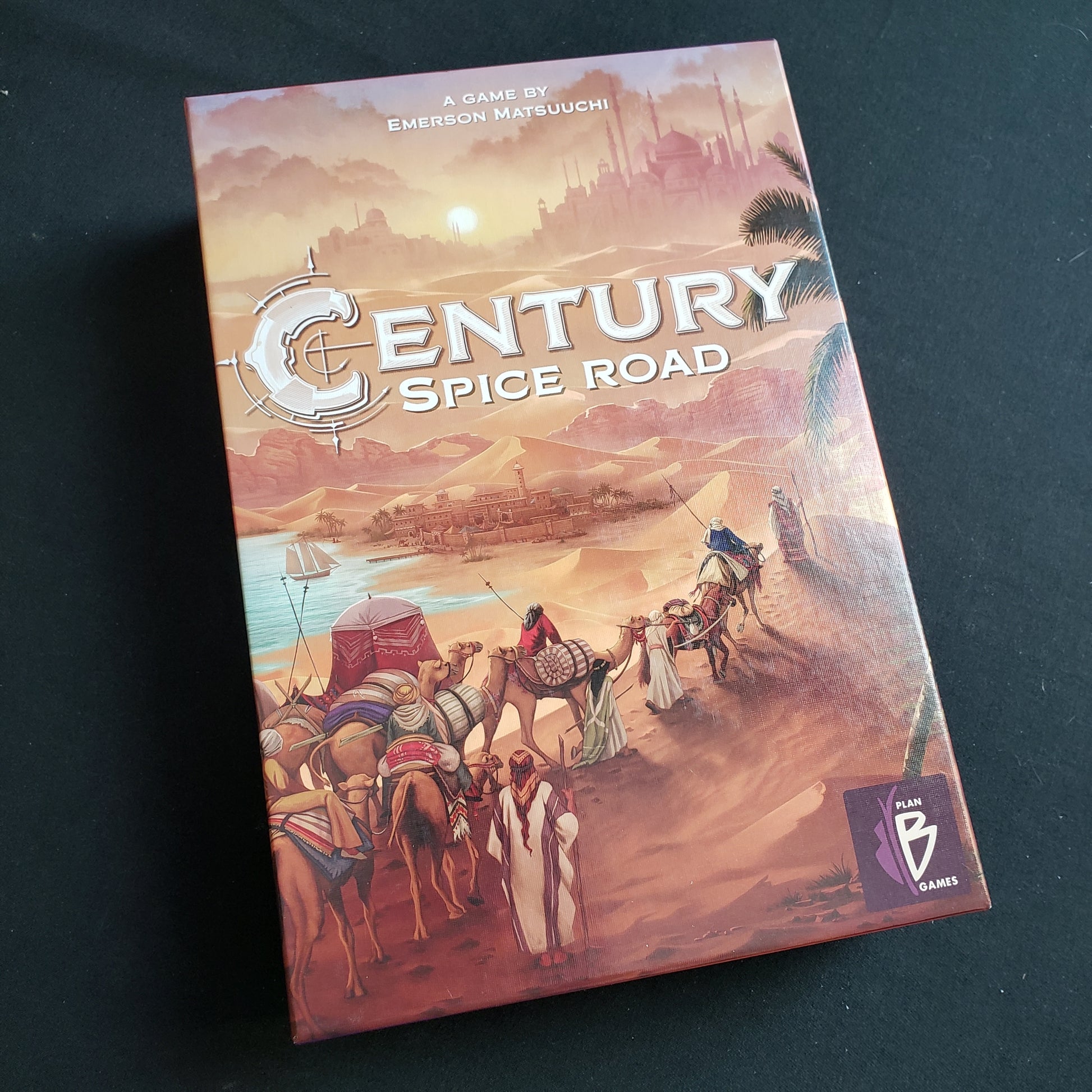 Image shows the front cover of the box of the Century: Spice Road board game