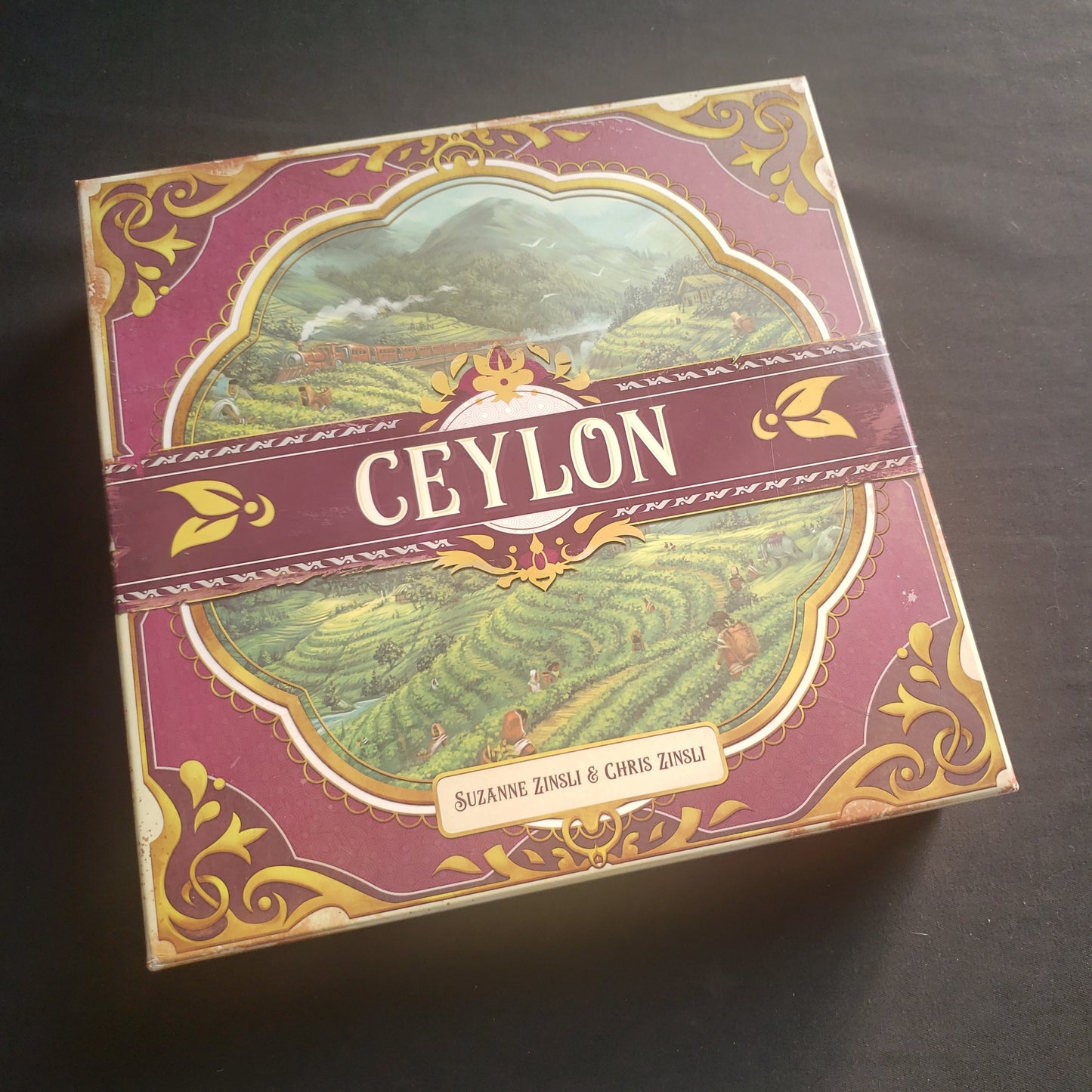 Image shows the front cover of the box of the Ceylon board game