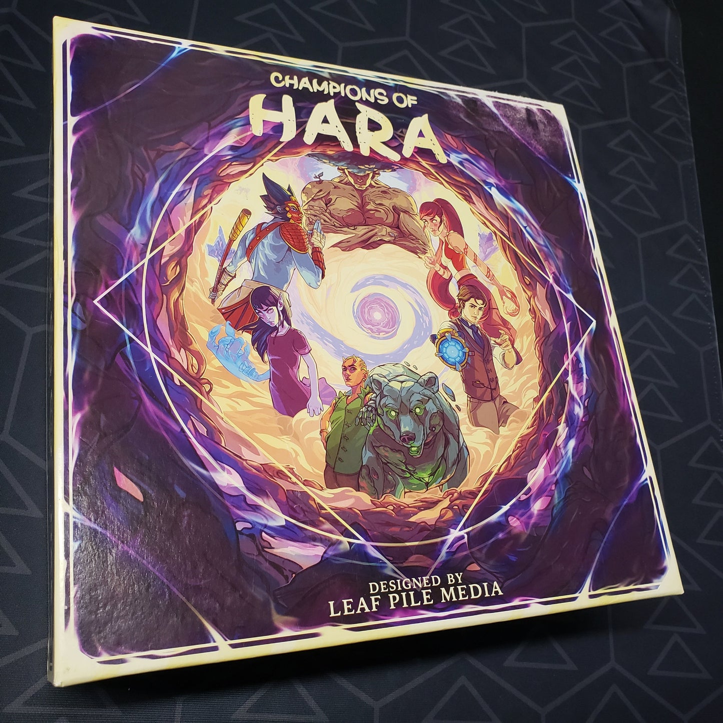 Image shows the front cover of the box for the Champions of Hara board game