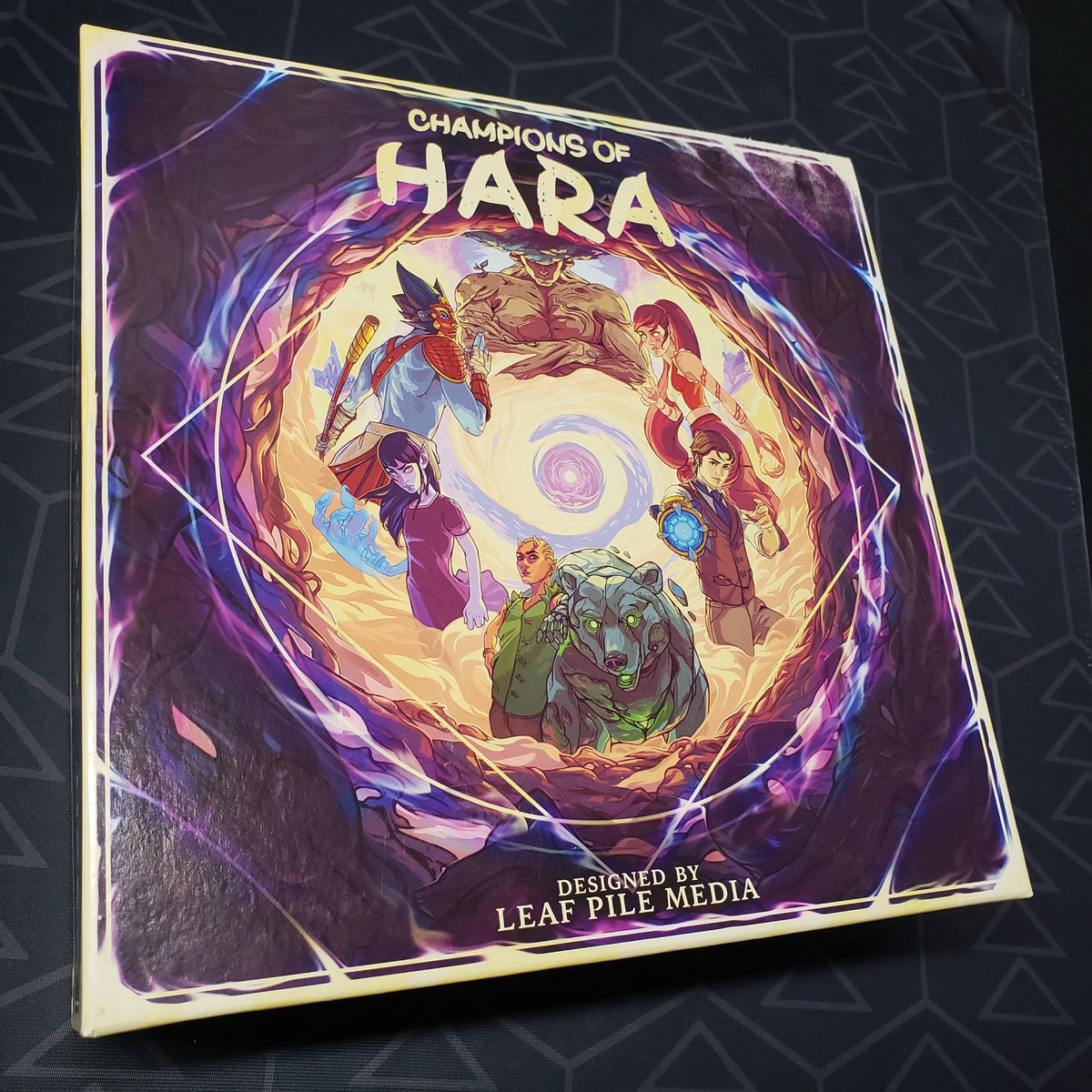 Image shows the front cover of the box for the Champions of Hara board game