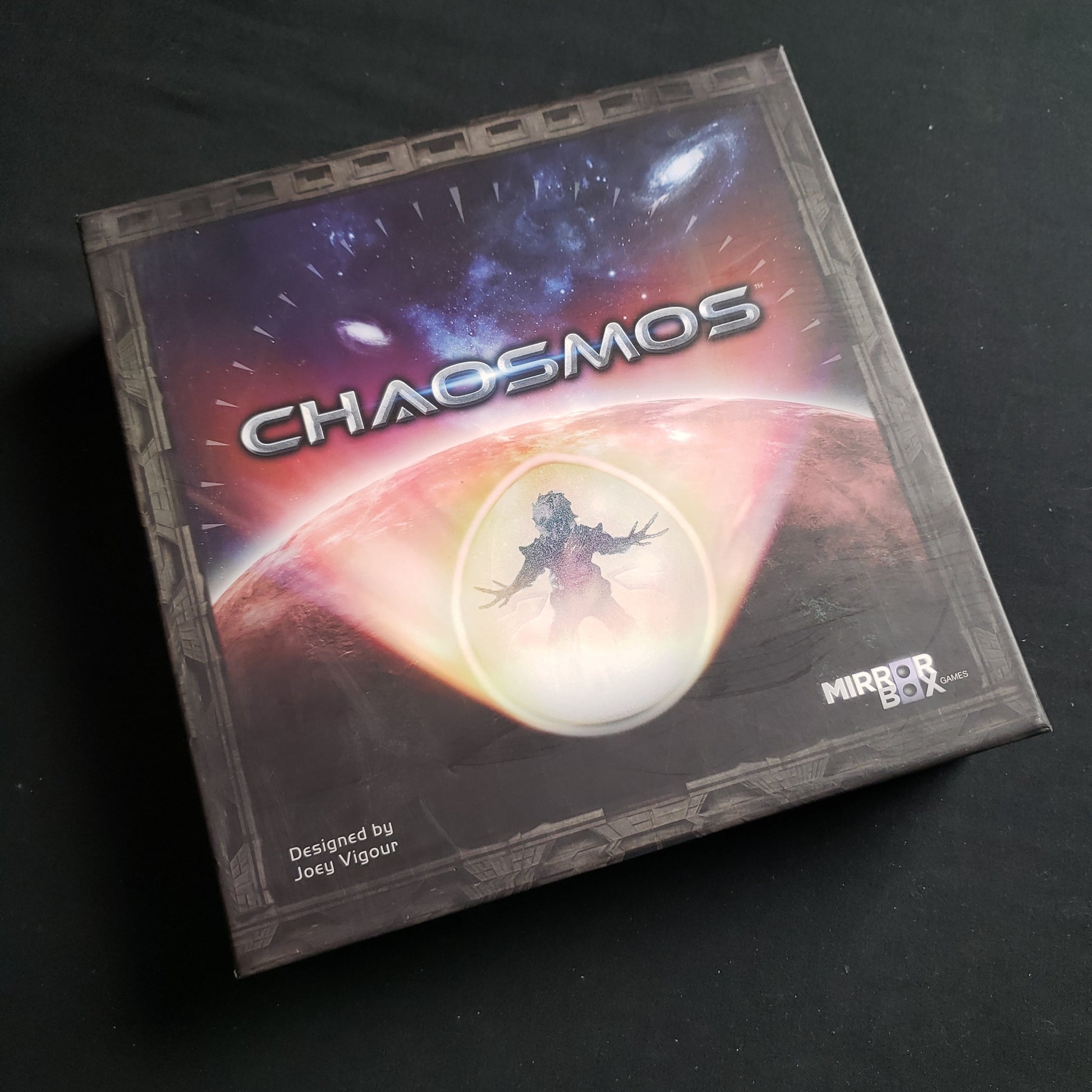 Image shows the front cover of the box of the Chaomos board game