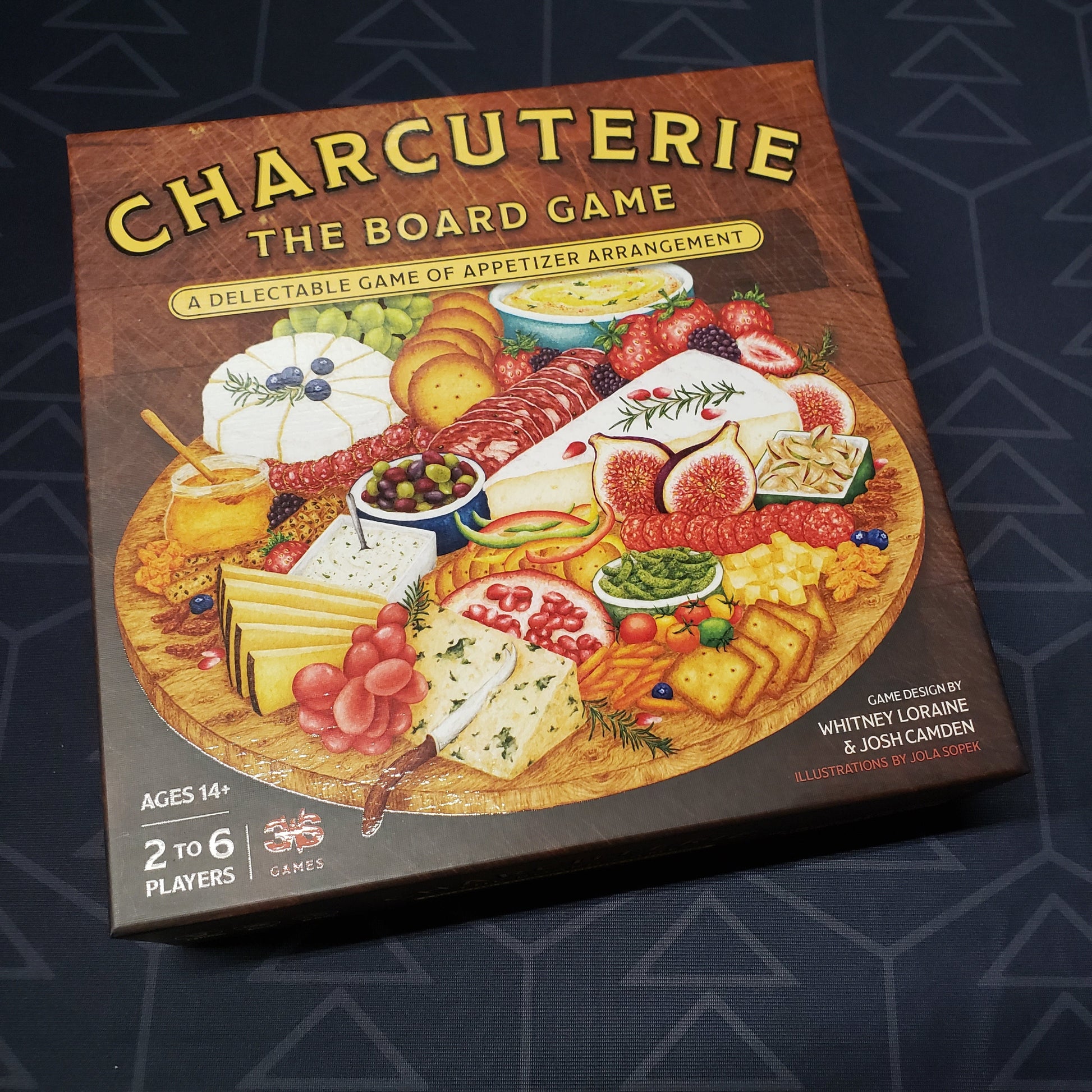 Image shows the front cover of the box for Charcuterie: The Board Game