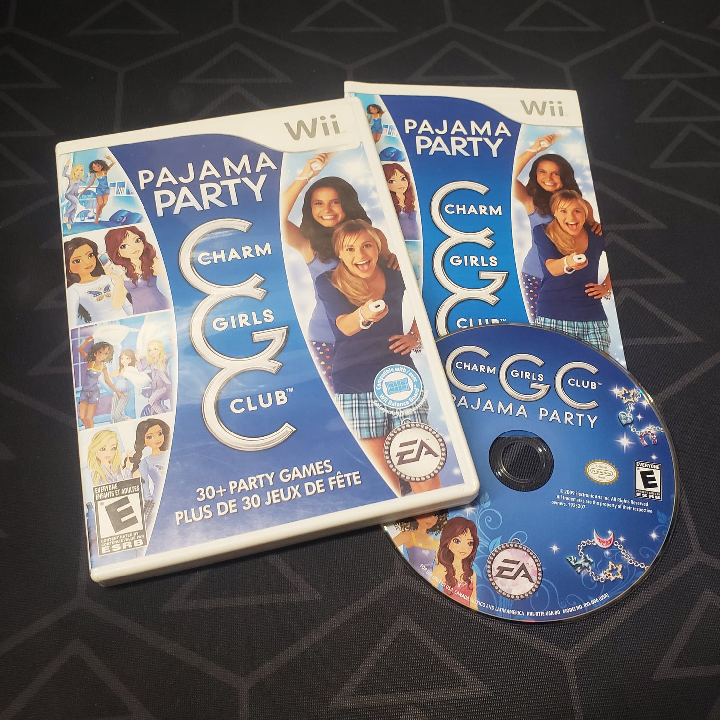 Image shows the case, manual and disc for the video game Charm Girls Club: Pajama Party for Nintendo Wii