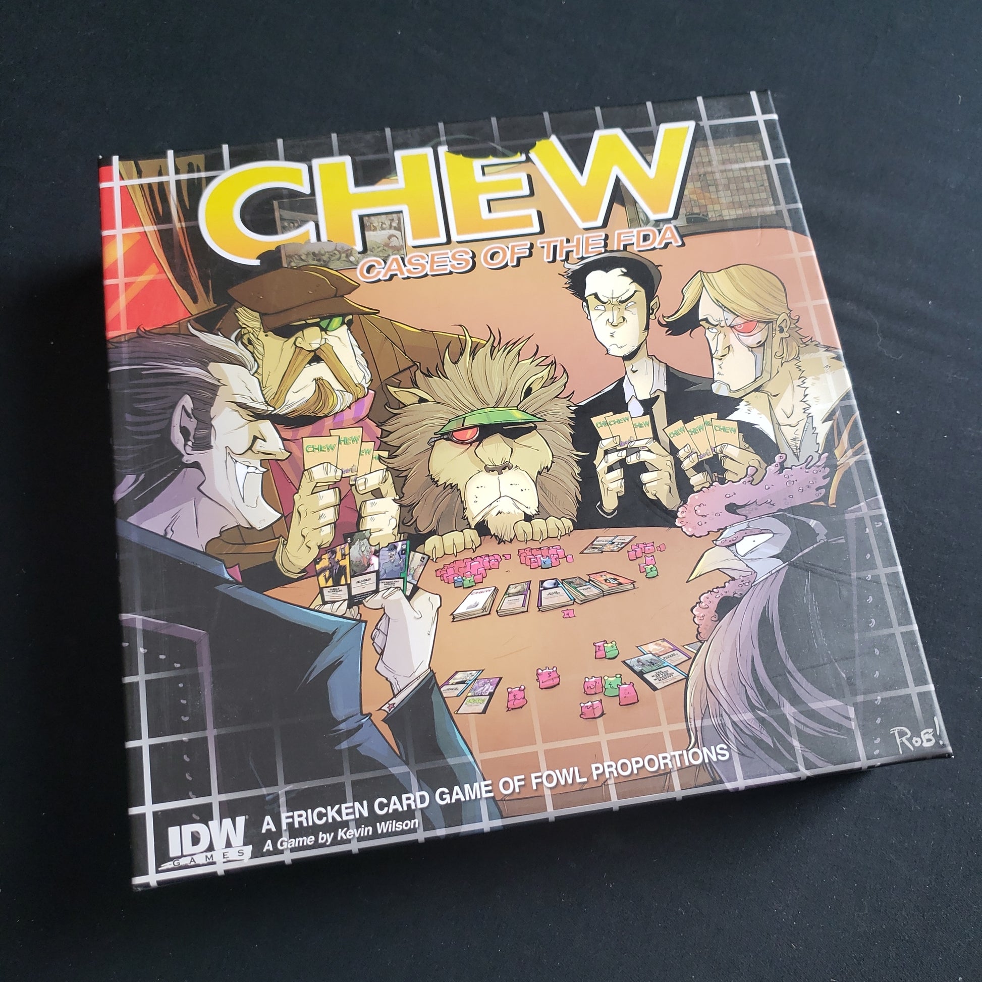 Image shows the front cover of the box of the CHEW: Cases of the FDA card game