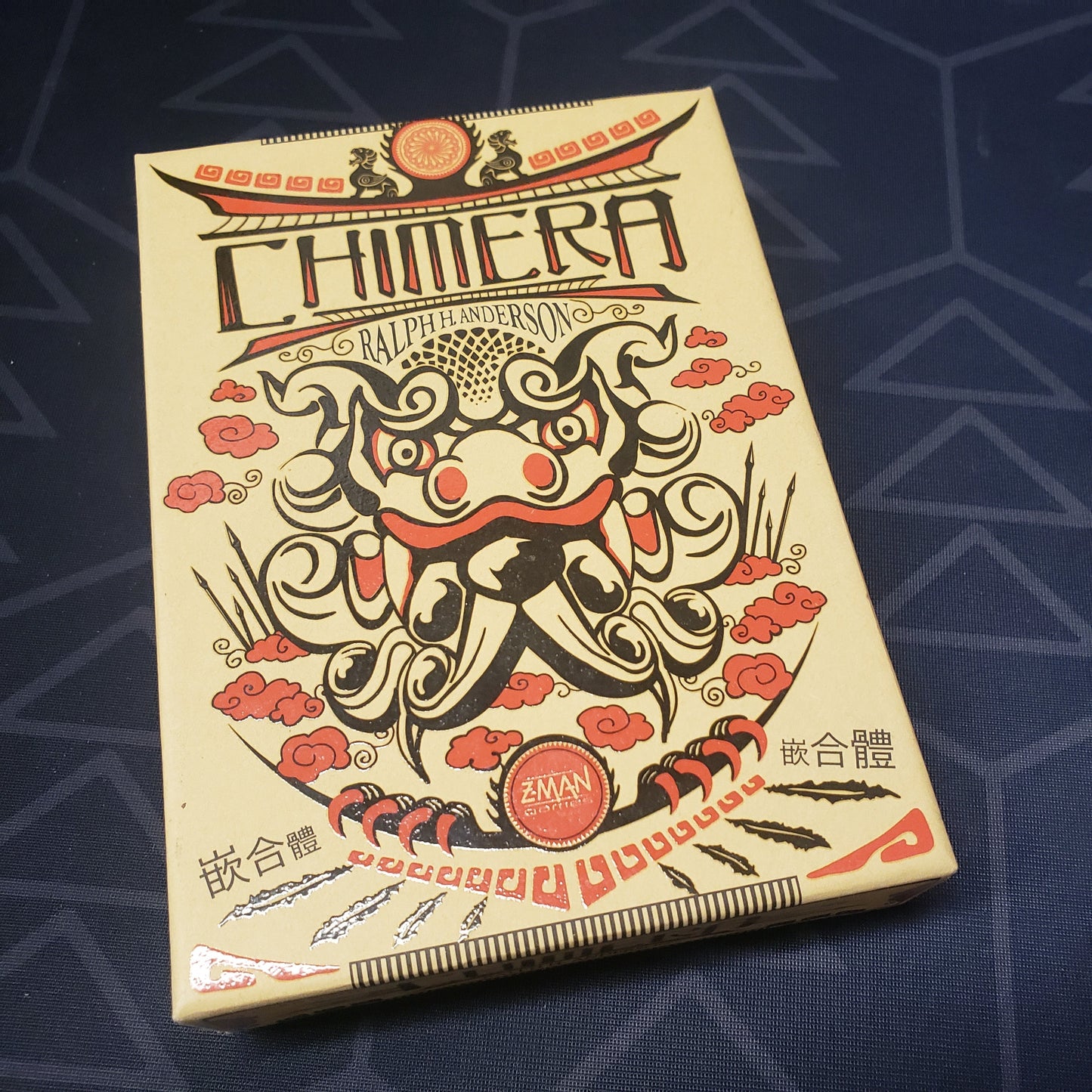 Image shows the front cover of the box of the Chimera card game