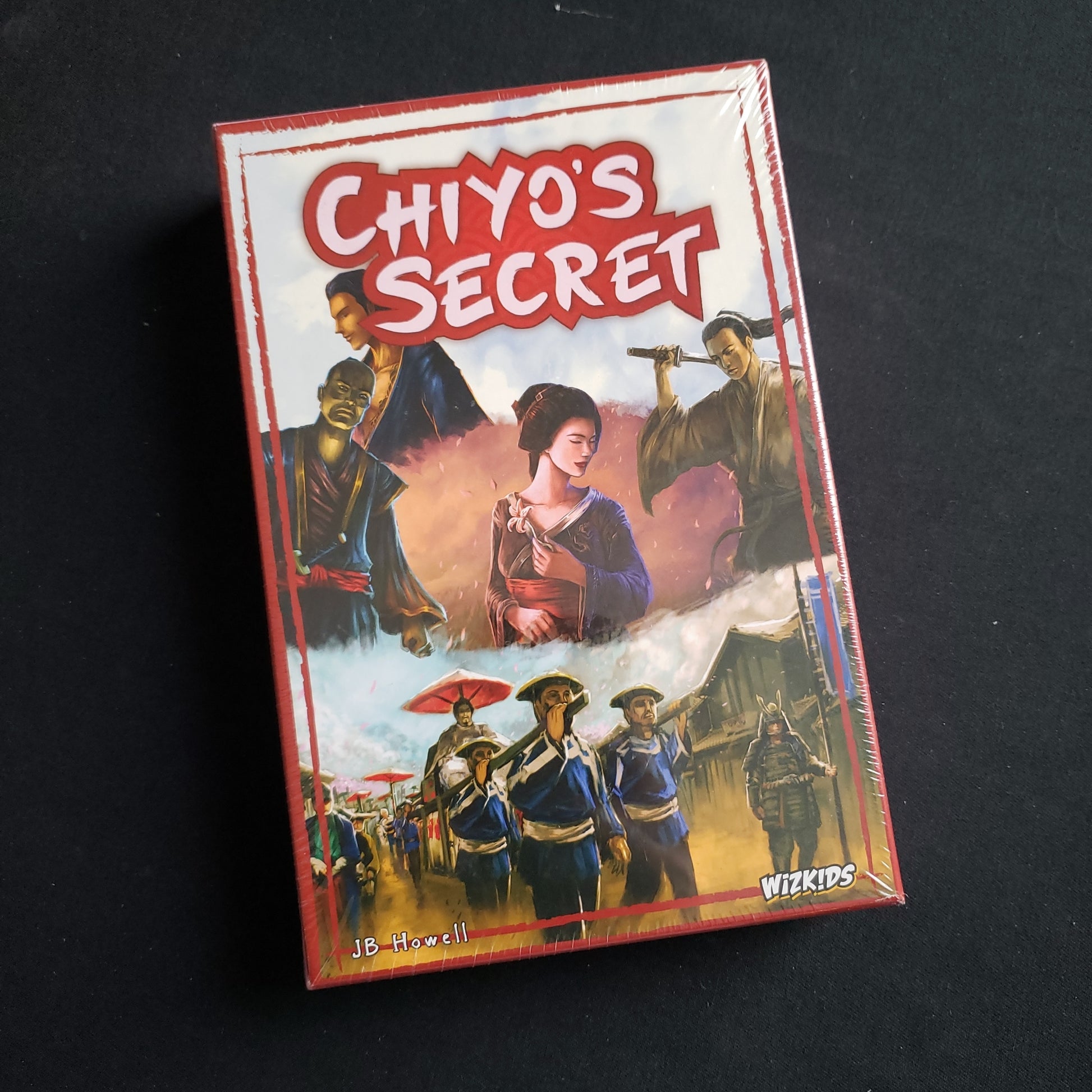 Image shows the front cover of the box of the Chiyo's Secret board game