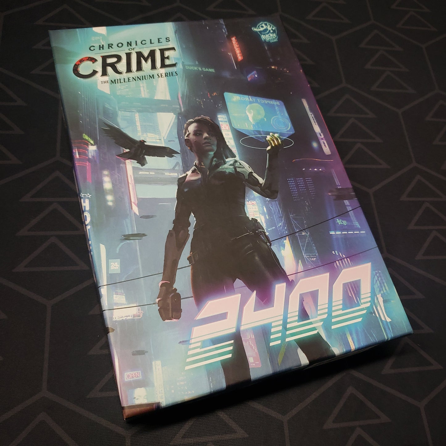 Image shows the front cover of the box for the Chronicles of Crime: 2400 board game