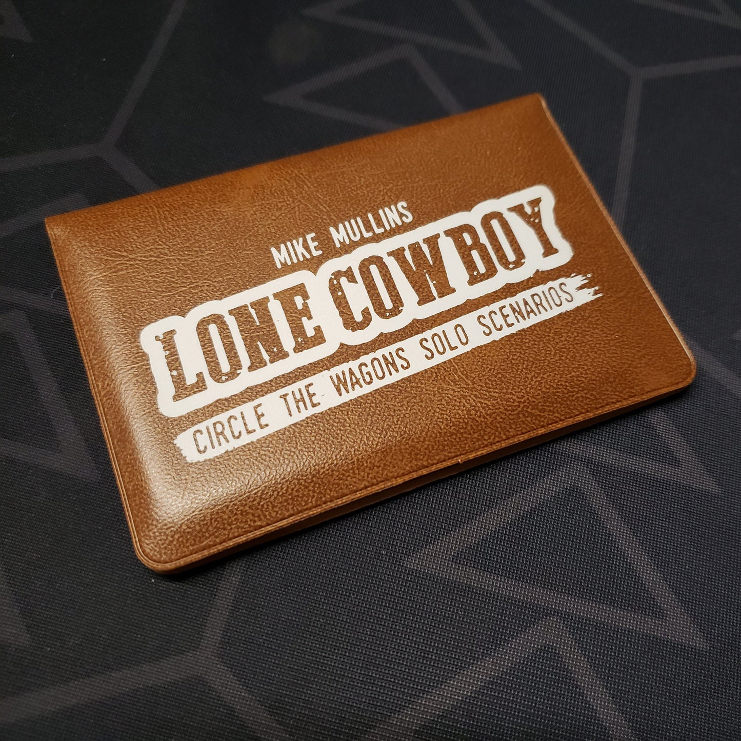 Image shows the front of the card wallet for the Lone Cowboy expansion for the card game Circle the Wagons