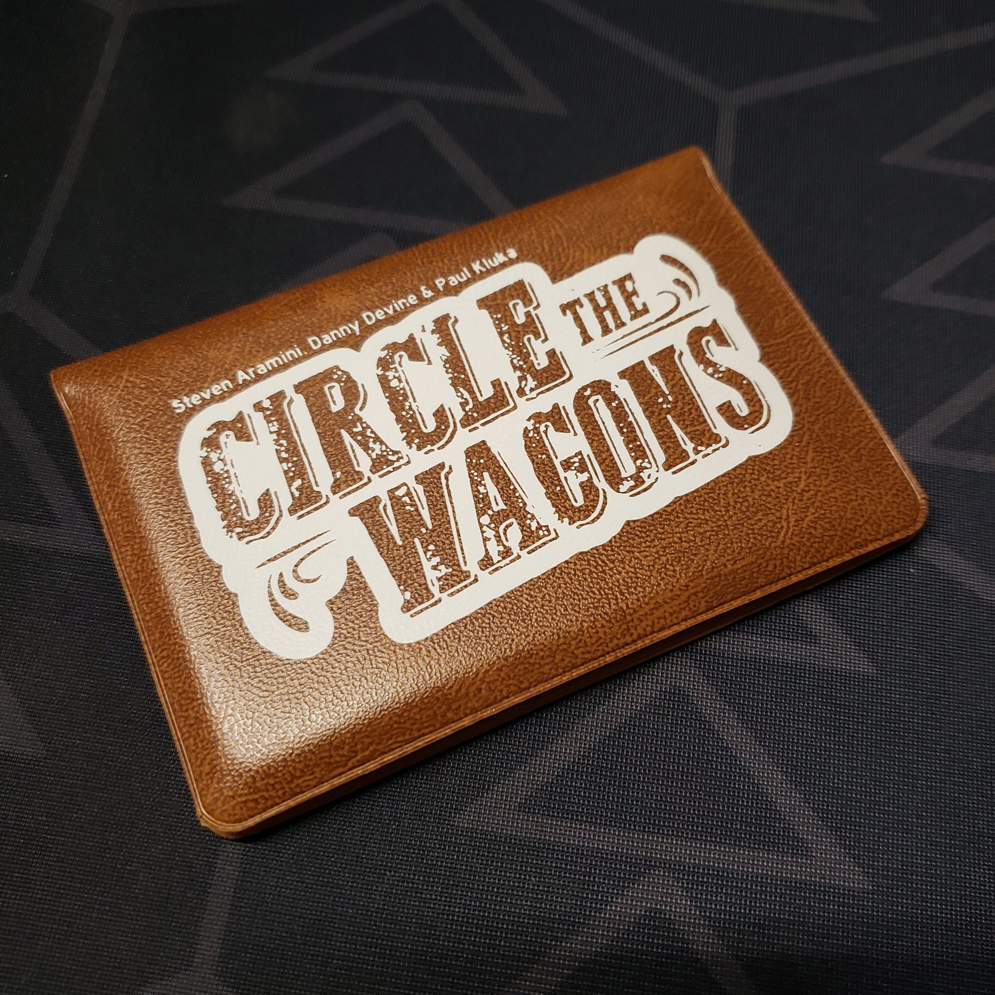 Image shows the front of the card wallet for the Circle the Wagons card game