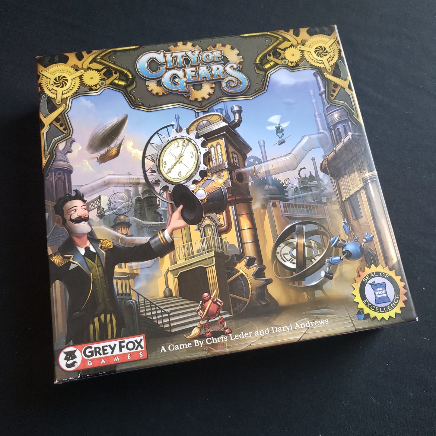 Image shows the front cover of the box of the City of Gears board game