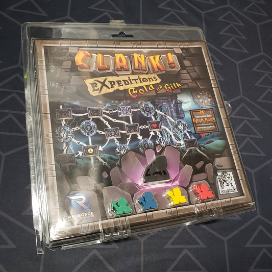 Image shows the front cover of the box of the Expeditions: Gold and Silk expansion for the board game Clank!