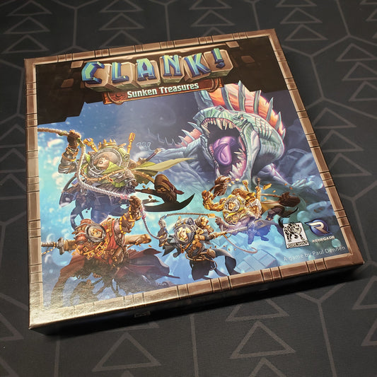 Image shows the front cover of the box of the Sunken Treasures expansion for the board game Clank!