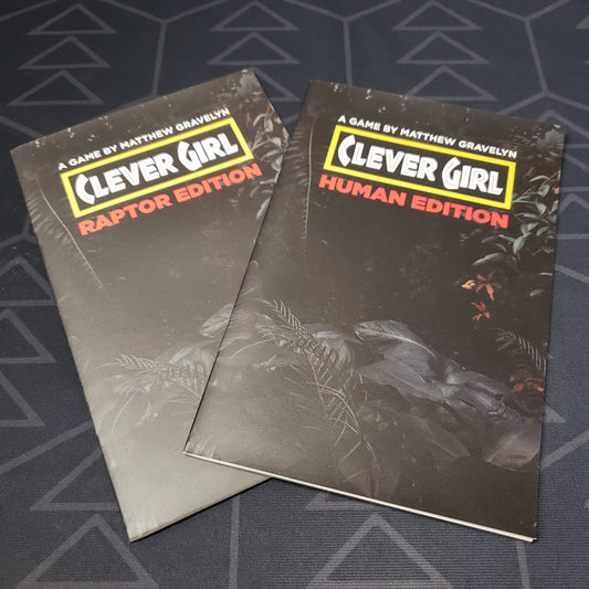 Image shows the front cover of both of the zines that make up the Clever Girl roleplaying game