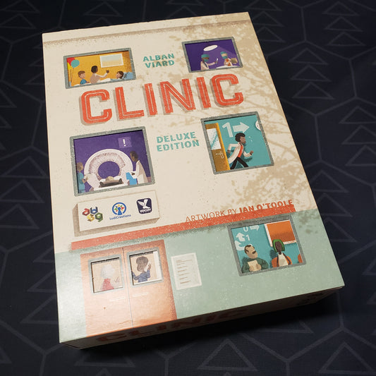 Image shows the front cover of the box of the deluxe edition of the board game Clinic