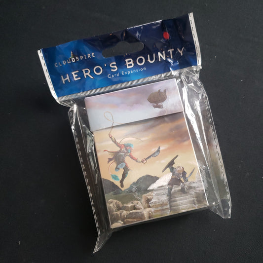 Image shows the front cover of the package of the Hero's Bounty Card Expansion for the board game Cloudspire
