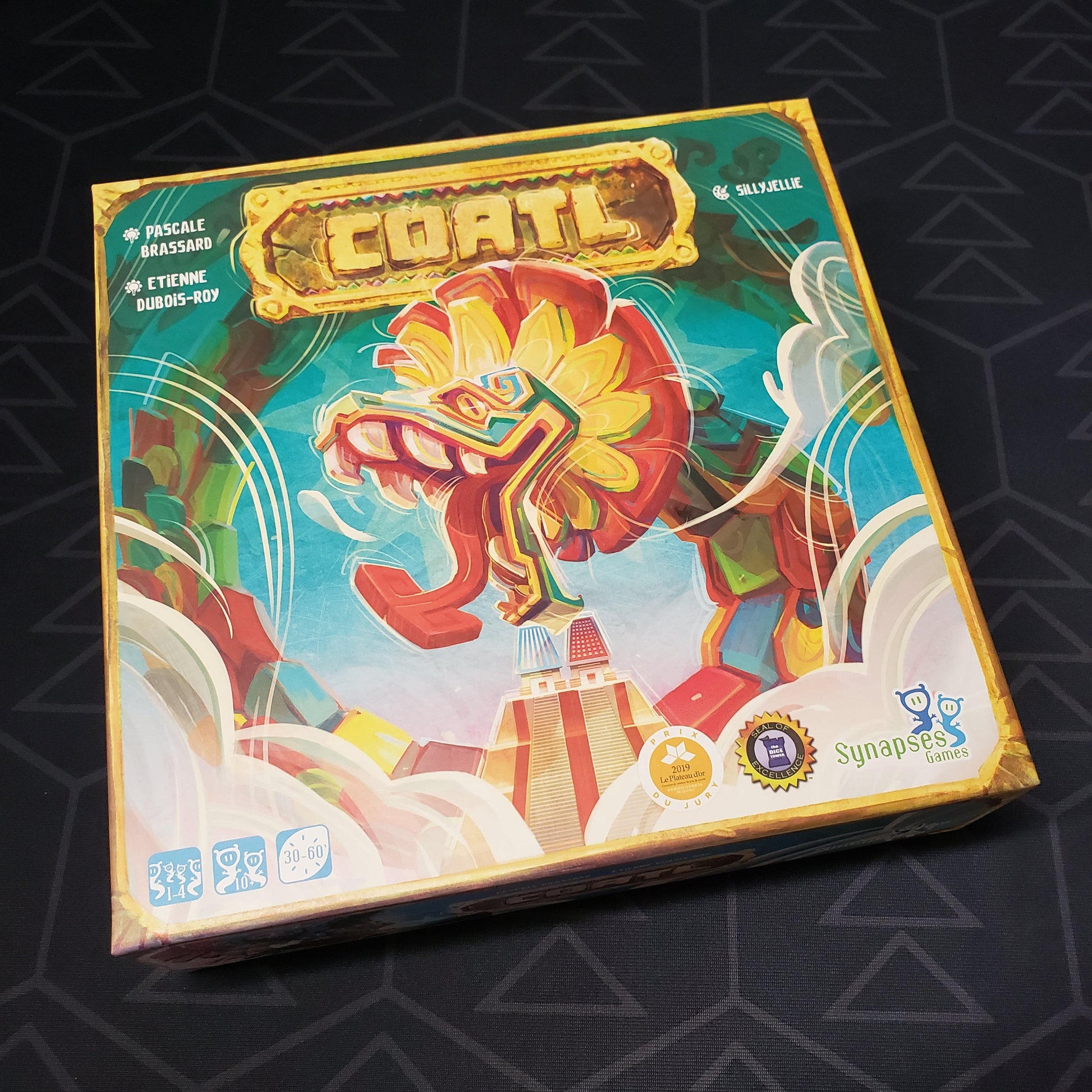 Image shows the front cover of the box of the Coatl board game