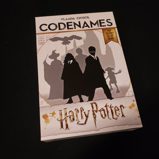 Image shows the front cover of the box of the Codenames: Harry Potter card game