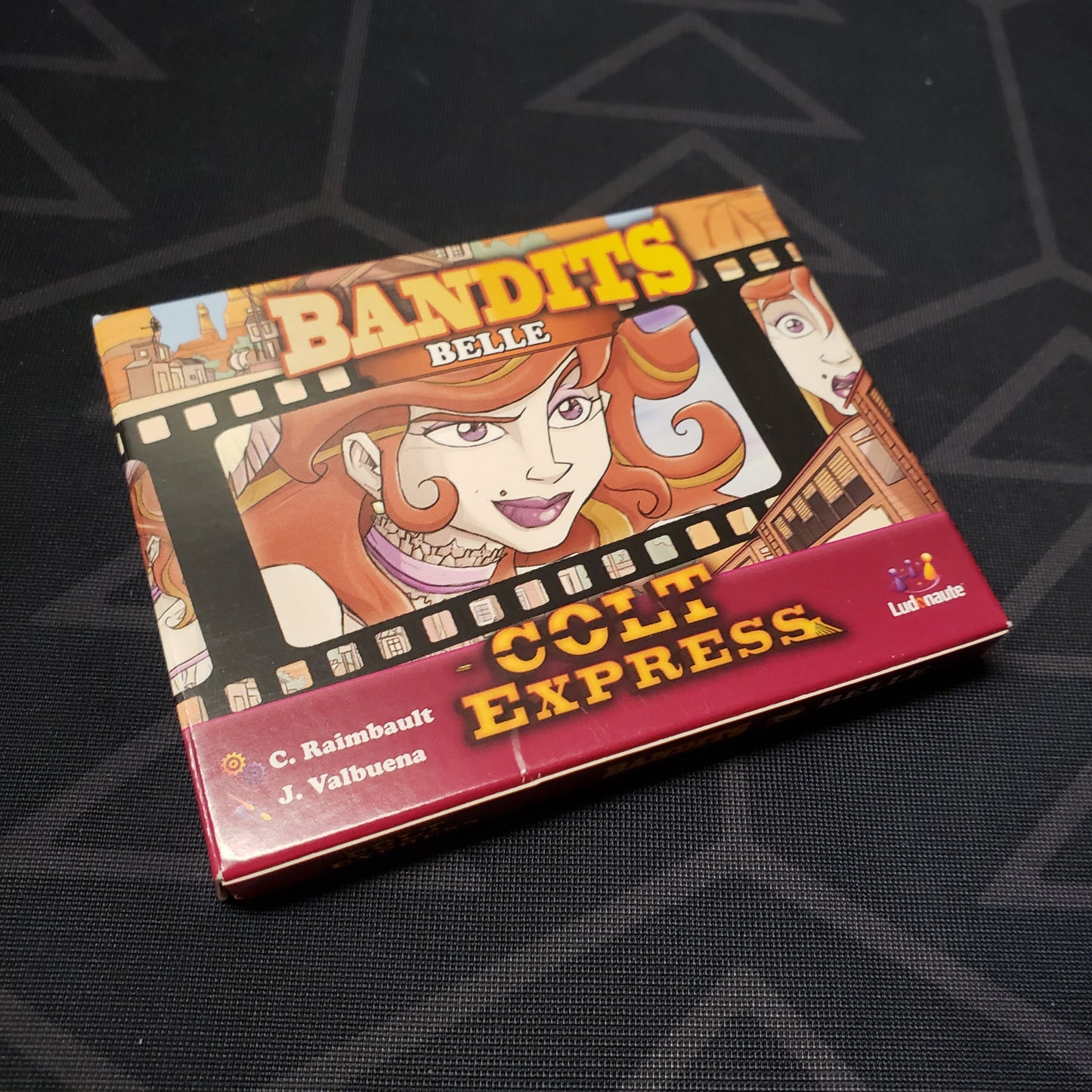 Image shows the front cover of the box of the Bandits: Belle expansion for the board game Colt Express