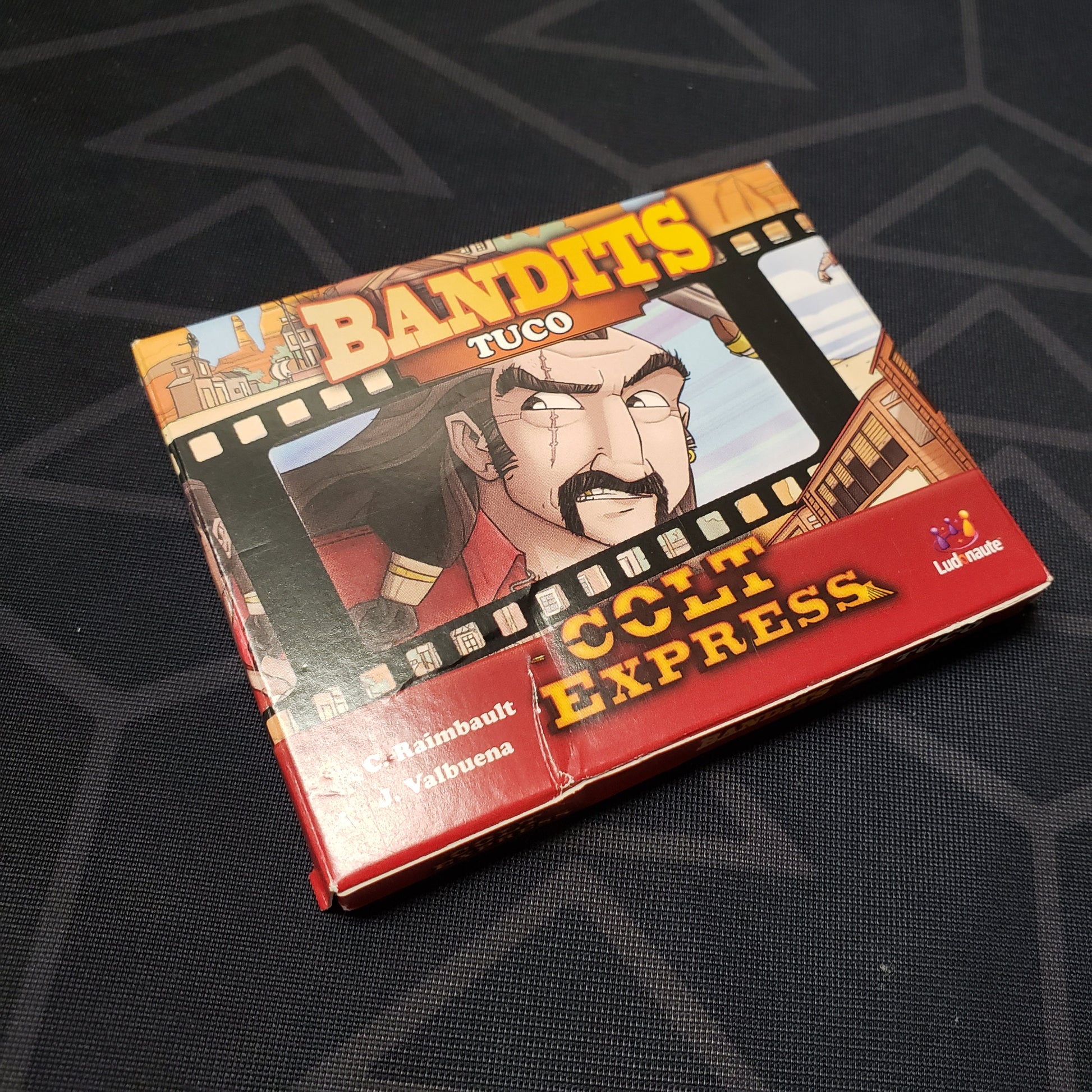 Image shows the front cover of the box of the Bandits: Tuco expansion for the board game Colt Express