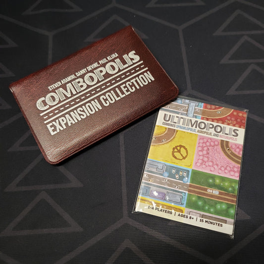 Image shows the front of the card wallet for the Combopolis: Expansion Collection for Sprawlopolis, Agropolis & Naturopols cards games, with the Ultimopolis expansion sitting next to it