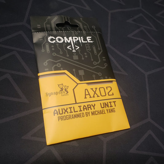 Image shows the front of the booster pack of the Aux 2 expansion for the card game Compile