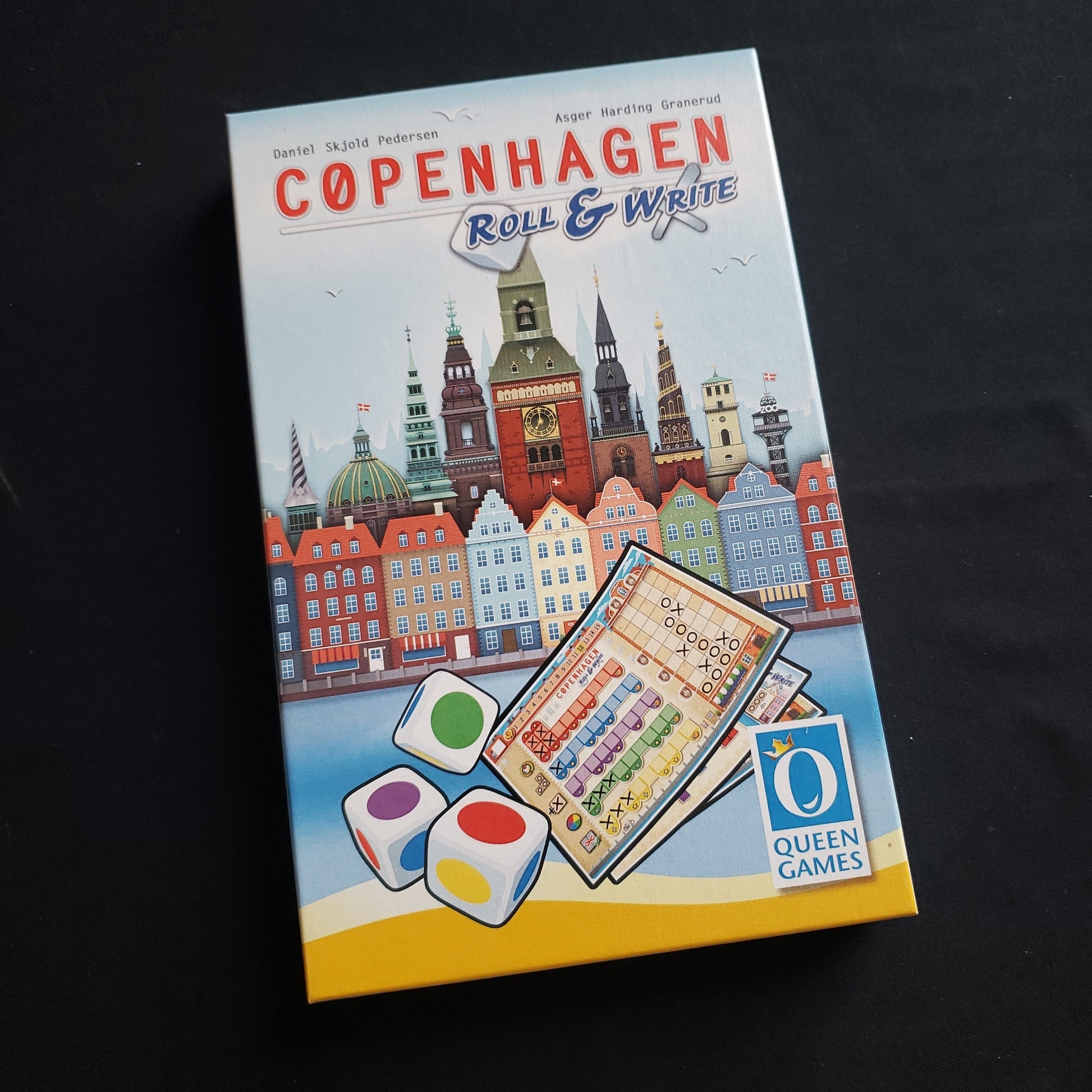 Image shows the front cover of the box of the Copenhagen: Roll & Write board game