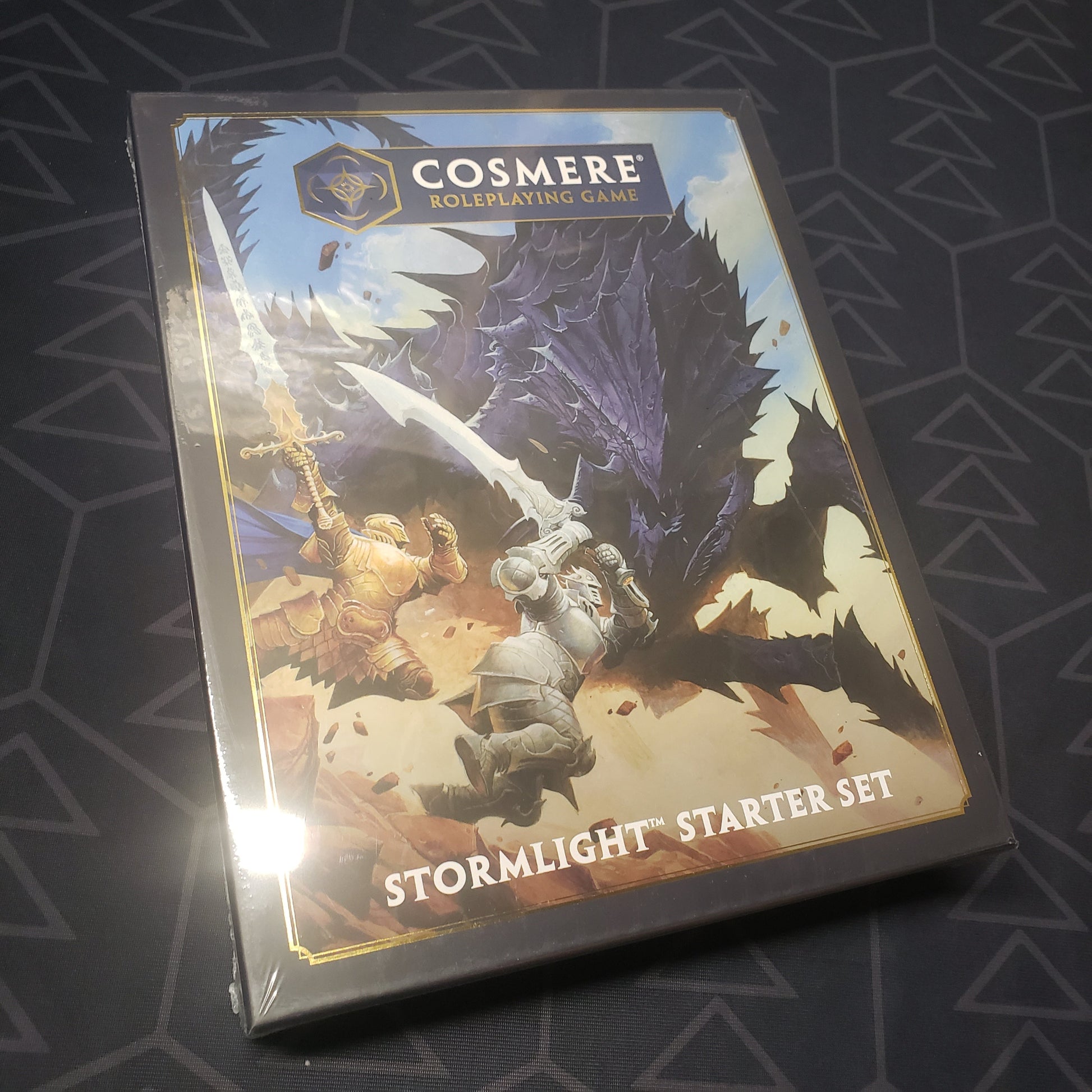 Image shows the front cover of the Stormlight Starter Set box for the roleplaying game Cosmere