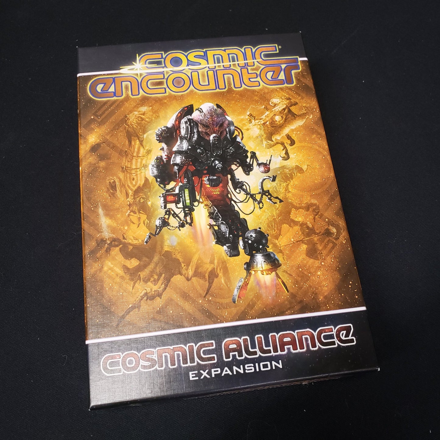 Image shows the front cover of the box for the Cosmic Alliance expansion from the board game Cosmic Encounter