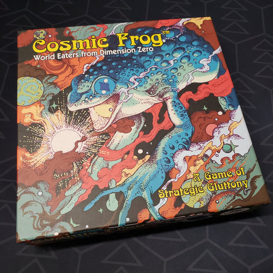 Image shows the front cover of the box for the Cosmic Frog board game