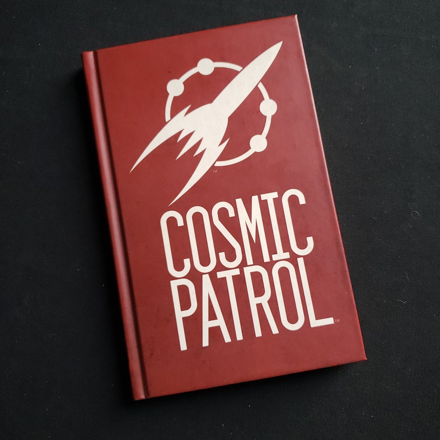 Image shows the front cover of the Core Rulebook for the Cosmic Patrol roleplaying game