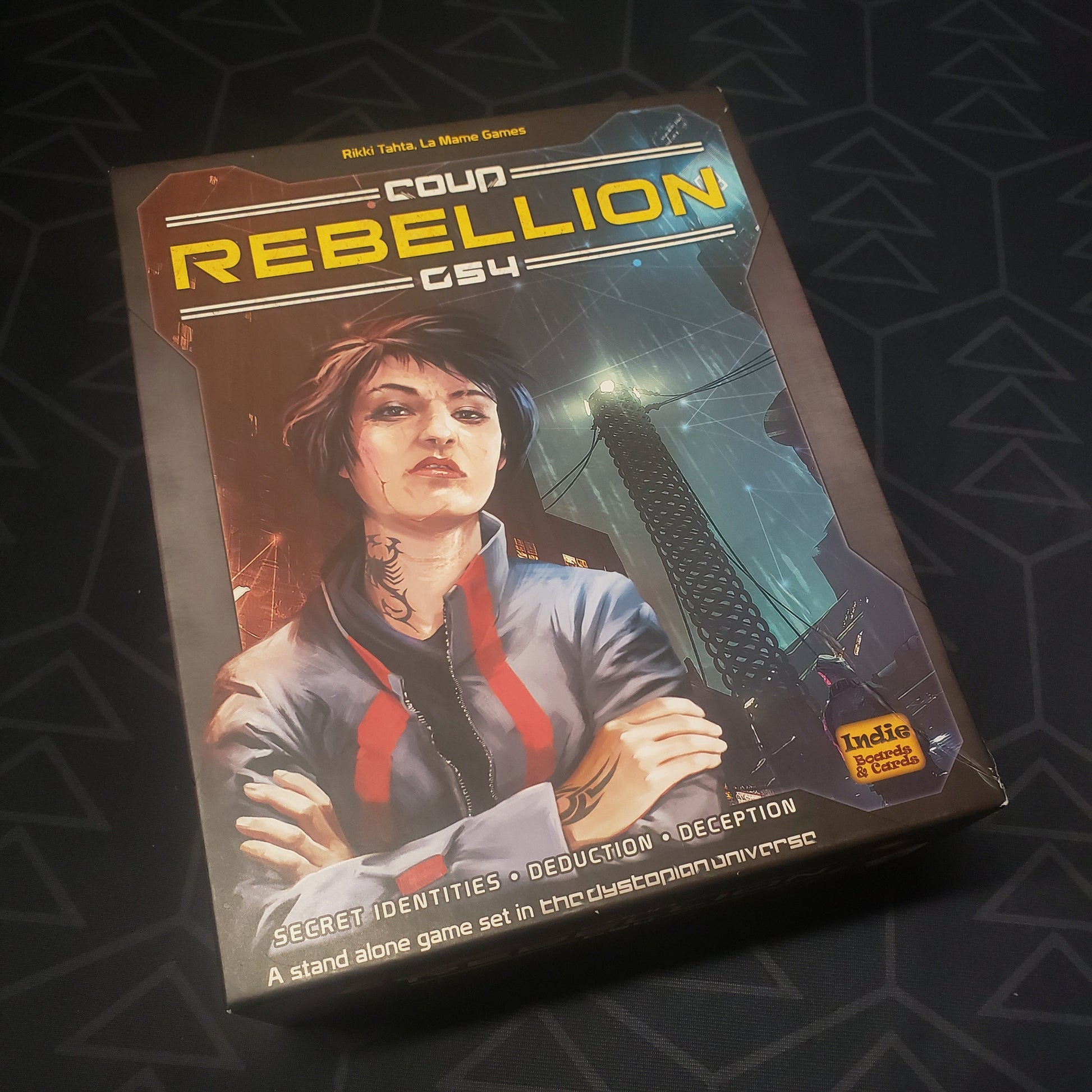 Image shows the front cover of the box of the Coup Rebellion G54 board game