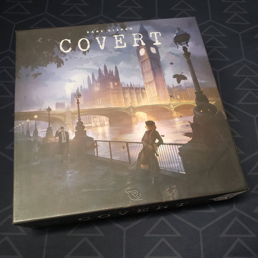 Image shows the front cover of the box for the Covert board game