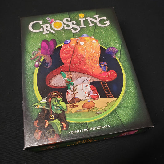 Image shows the front cover of the box of the Crossing card game