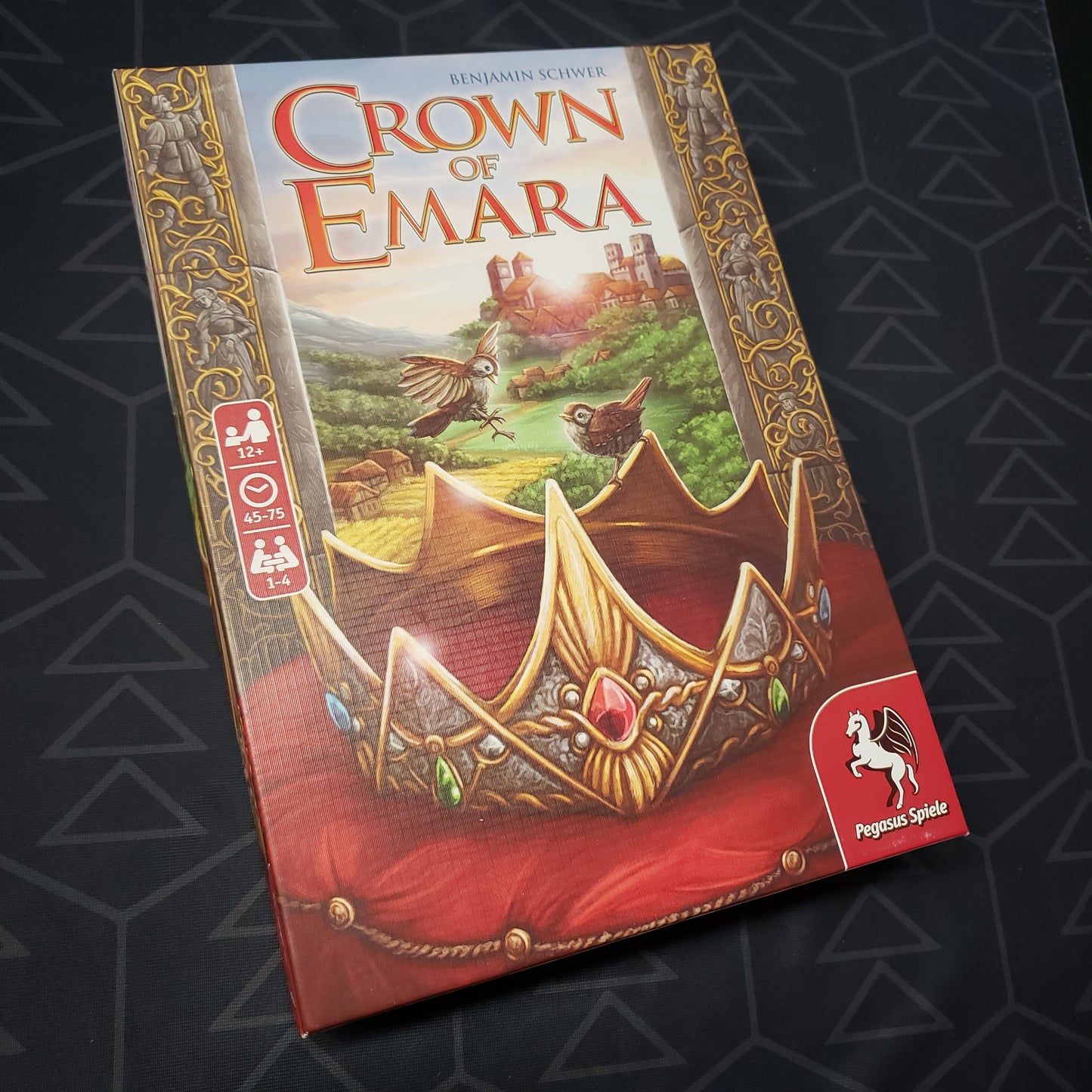 Image shows the front cover of the box for the Crown of Emara board game
